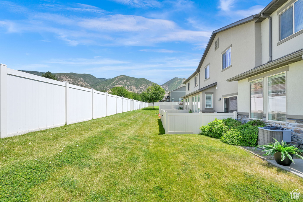 Fenced yard featuring a mountain view