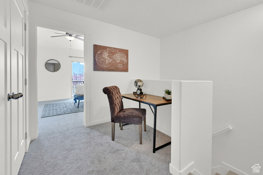 Office space featuring carpet floors and a ceiling fan