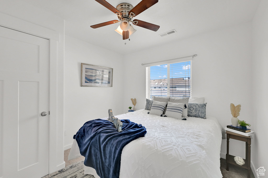 Bedroom featuring a ceiling fan and carpet floors