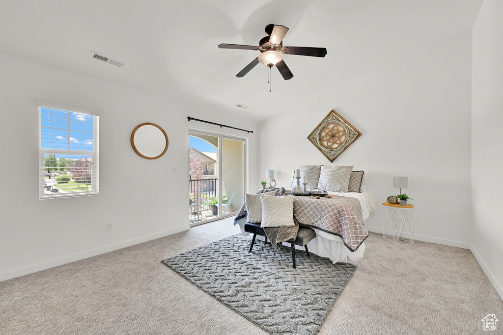 Bedroom featuring access to outside, carpet, and ceiling fan