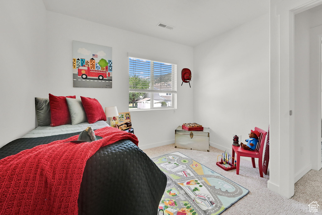Bedroom featuring carpet flooring and baseboards