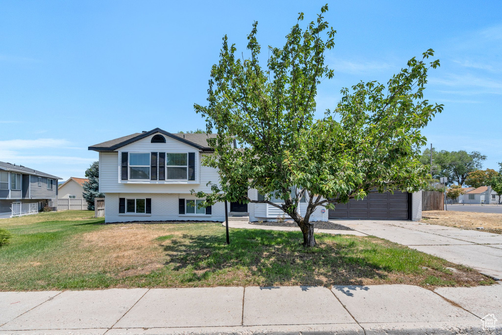 View of front of house with a garage and concrete driveway