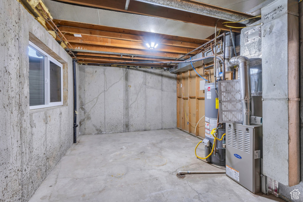 Unfinished basement with gas water heater and heating unit