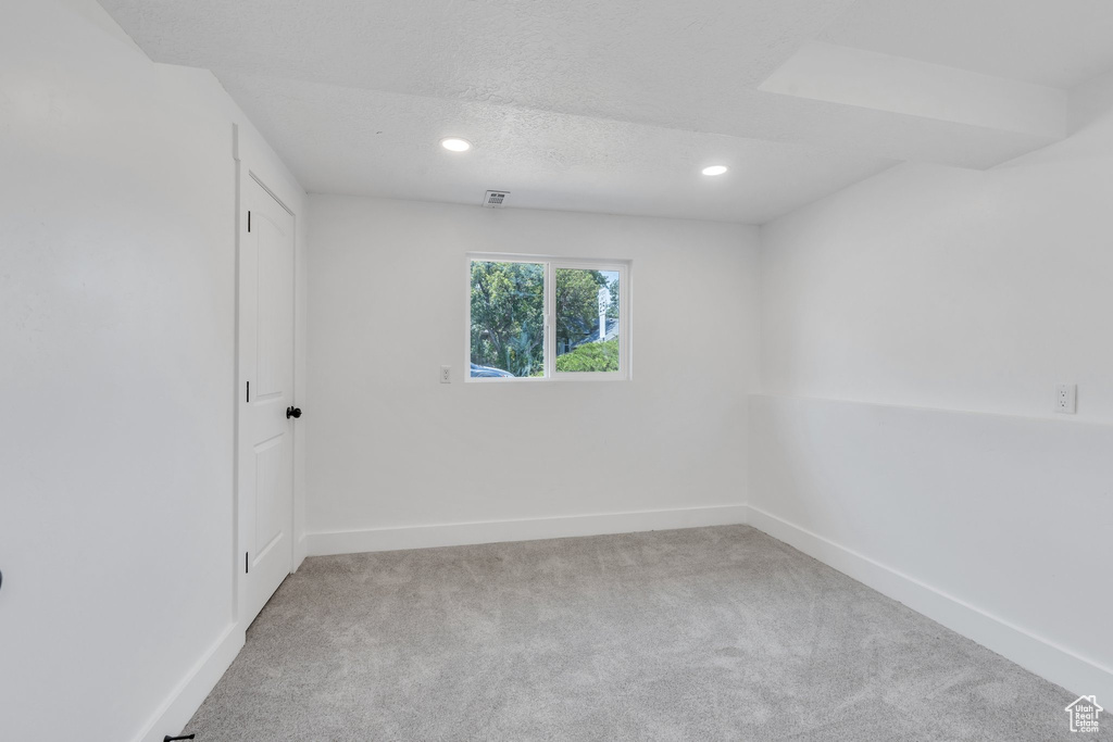 Carpeted spare room featuring recessed lighting and a textured ceiling