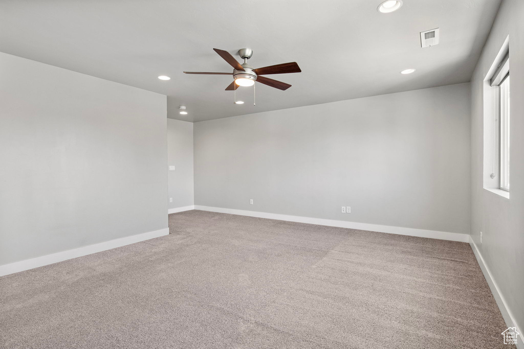 Unfurnished room with a ceiling fan, carpet floors, and recessed lighting