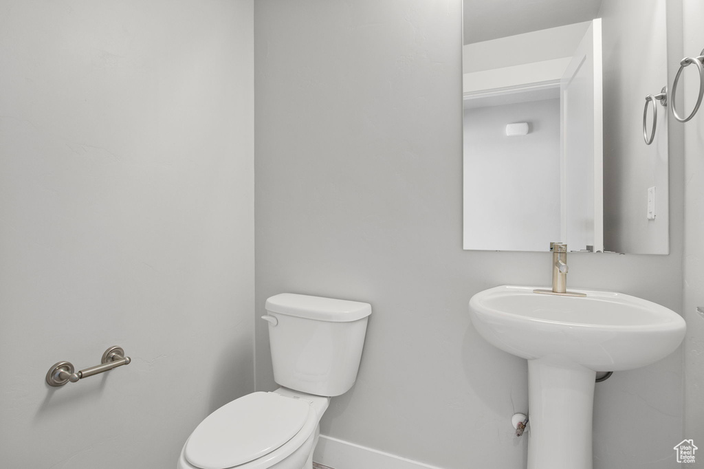 Bathroom with toilet and baseboards