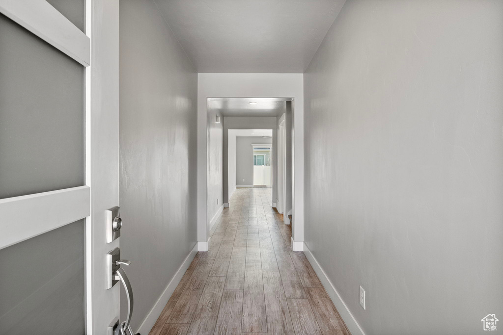 Hall with wood finished floors and baseboards