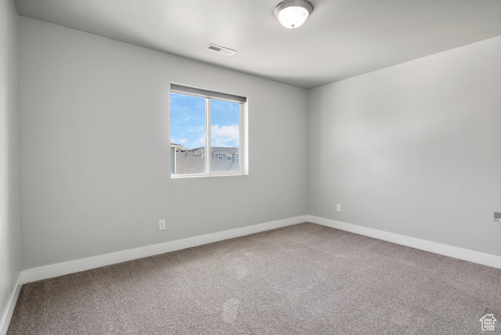Spare room featuring carpet floors