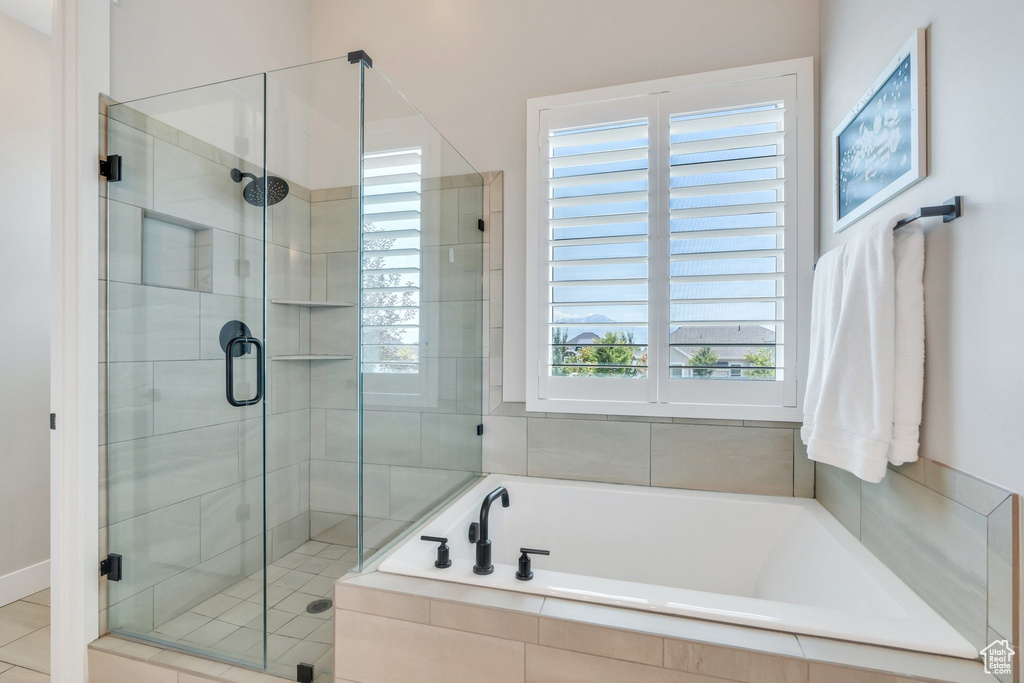 Full bath featuring a shower stall and a garden tub