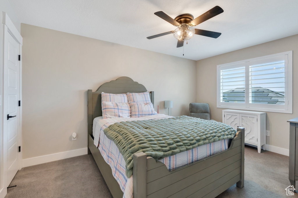 Bedroom with light carpet and ceiling fan