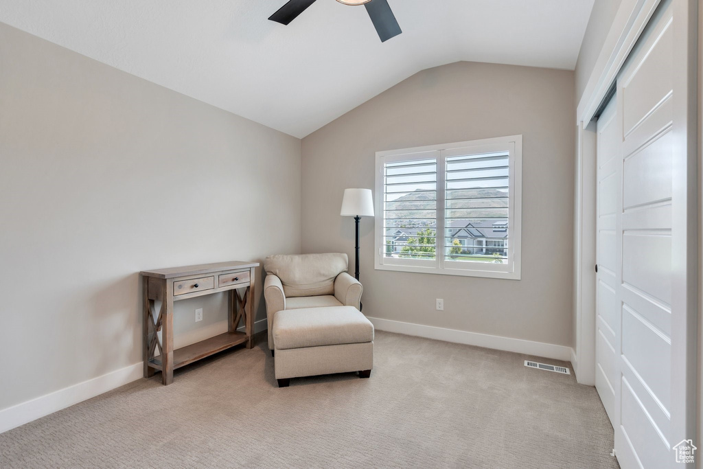 Sitting room with a ceiling fan, lofted ceiling, and light carpet