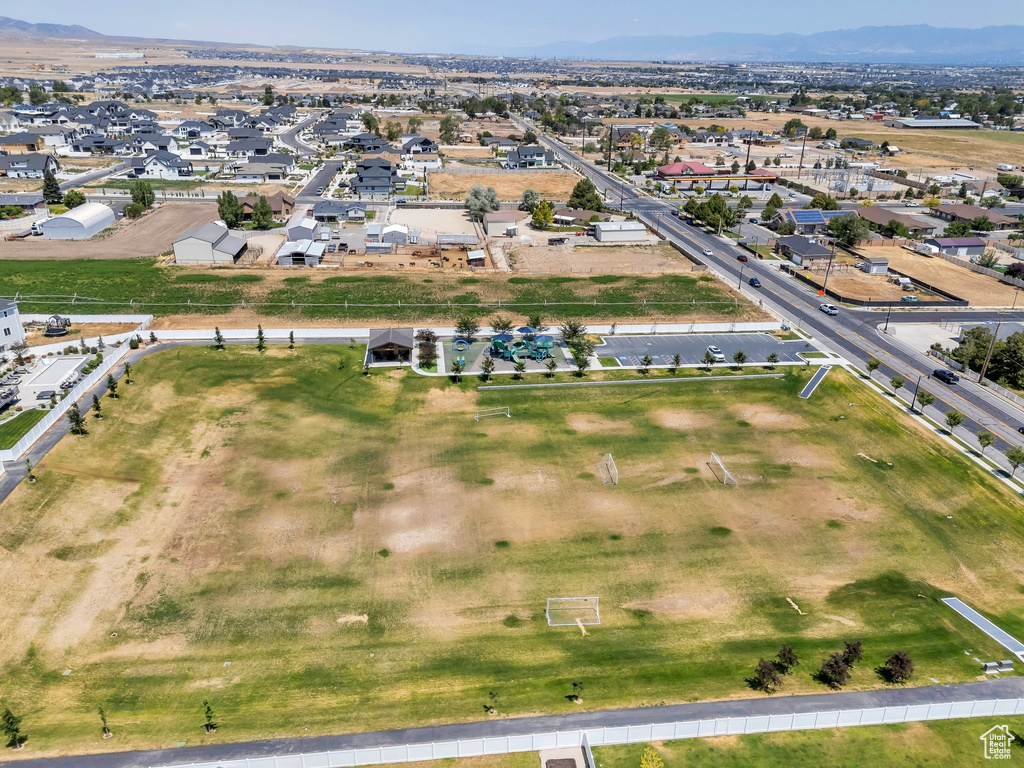 Aerial overview of property\'s location with a mountain backdrop and nearby suburban area