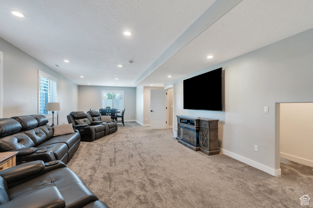 Carpeted living room featuring recessed lighting and a fireplace
