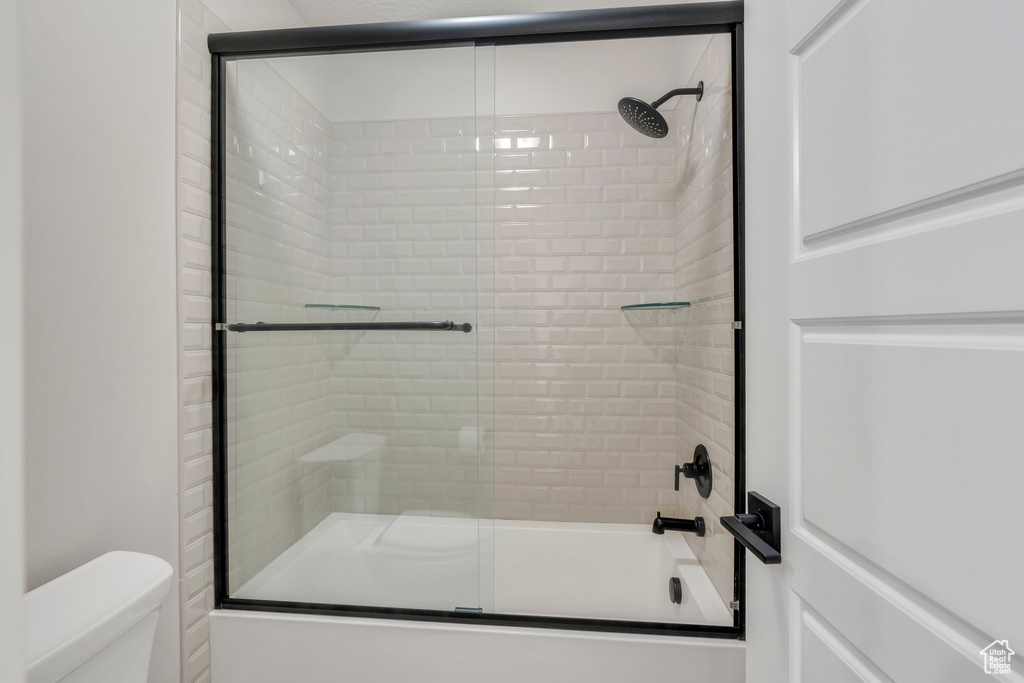 Bathroom featuring enclosed tub / shower combo