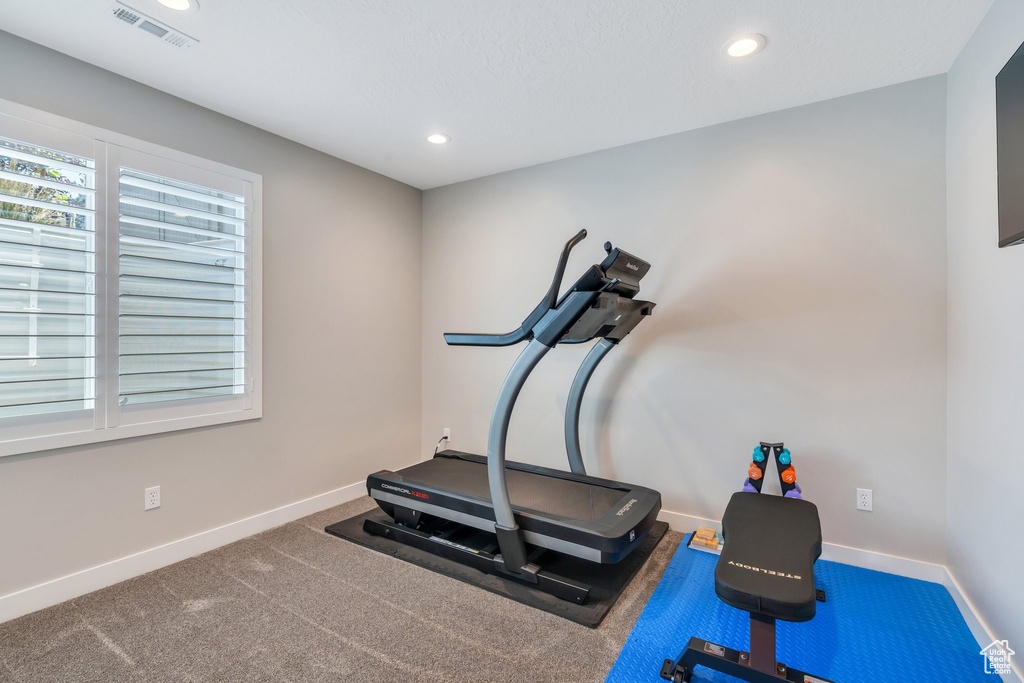 Workout area featuring baseboards and recessed lighting