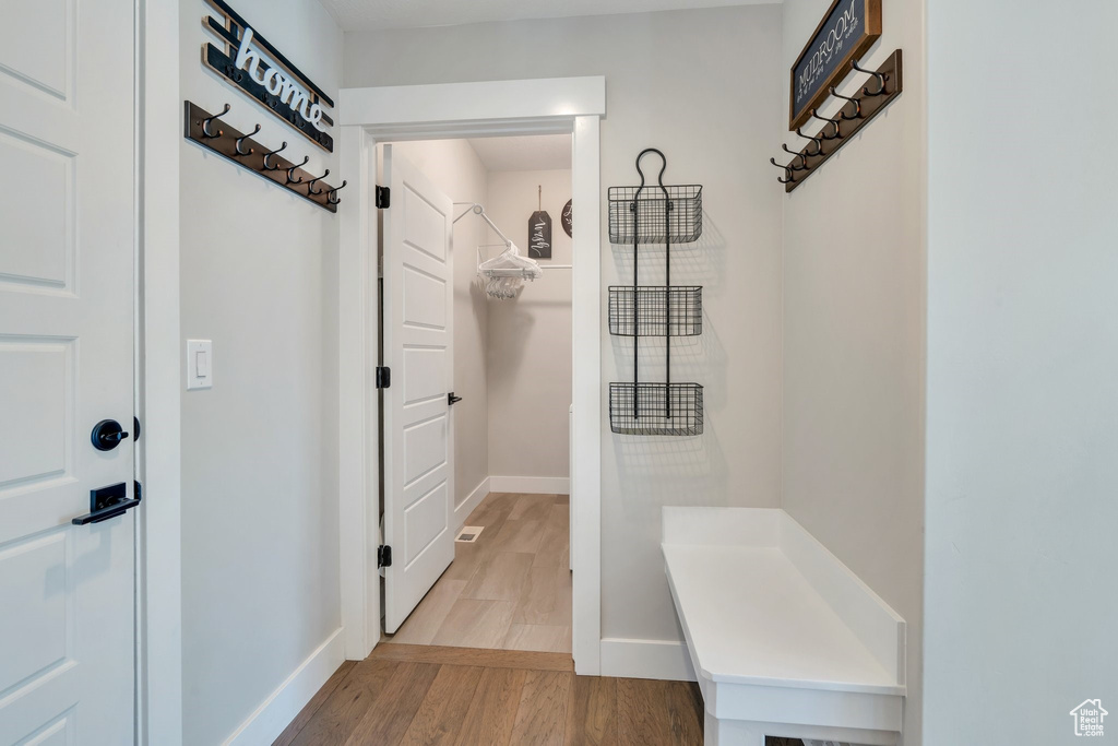 Mudroom featuring baseboards and light wood-type flooring