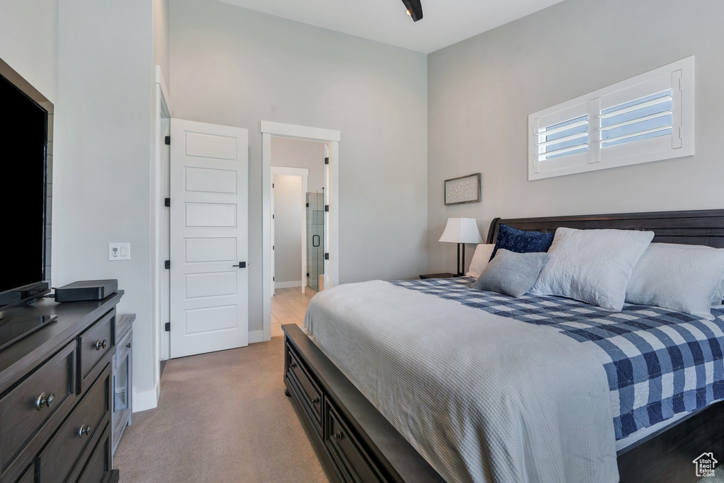 Bedroom with light carpet and baseboards