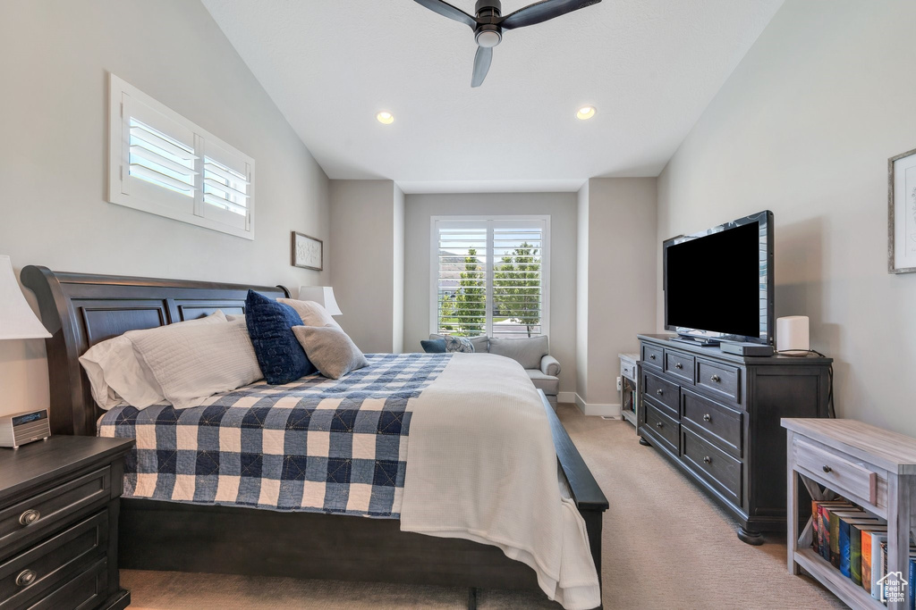 Bedroom featuring light colored carpet, a ceiling fan, and recessed lighting