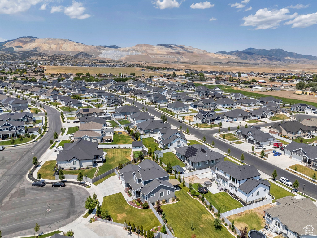 Aerial overview of property\'s location with nearby suburban area and a mountainous background