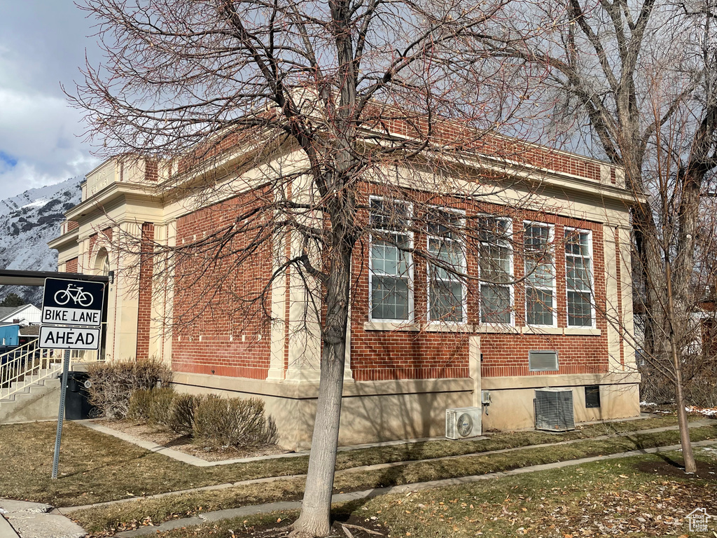 View of home's exterior with brick siding and a mountain view