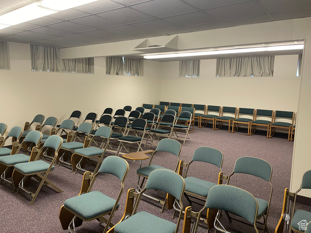 Misc room with a paneled ceiling and carpet floors