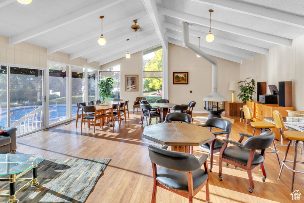 Dining space with wood finished floors and a wood stove