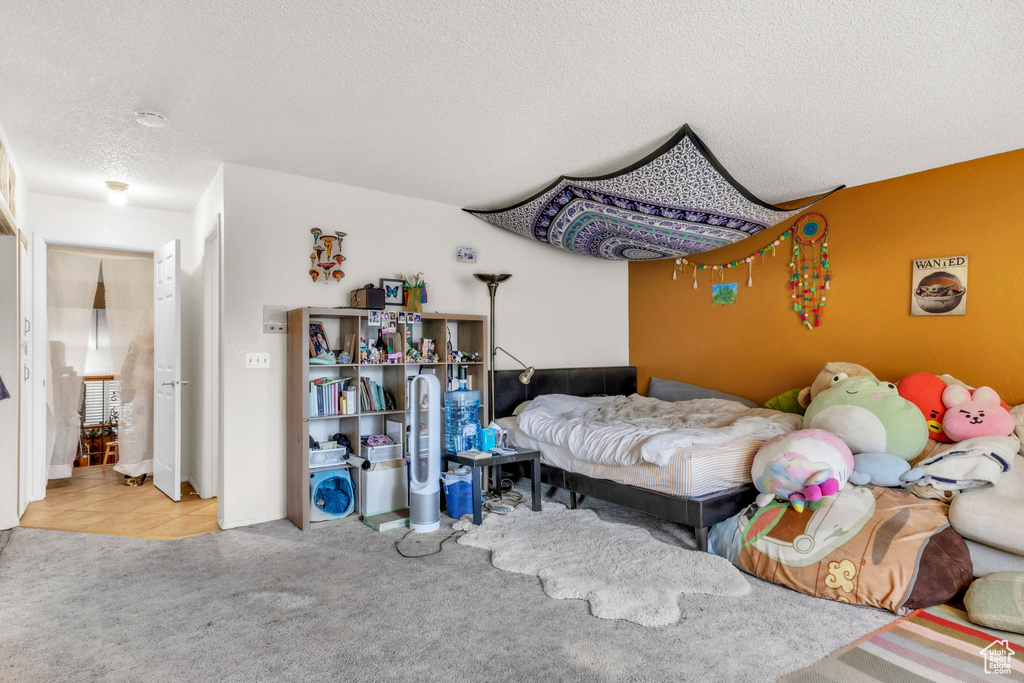 Bedroom featuring a textured ceiling and carpet