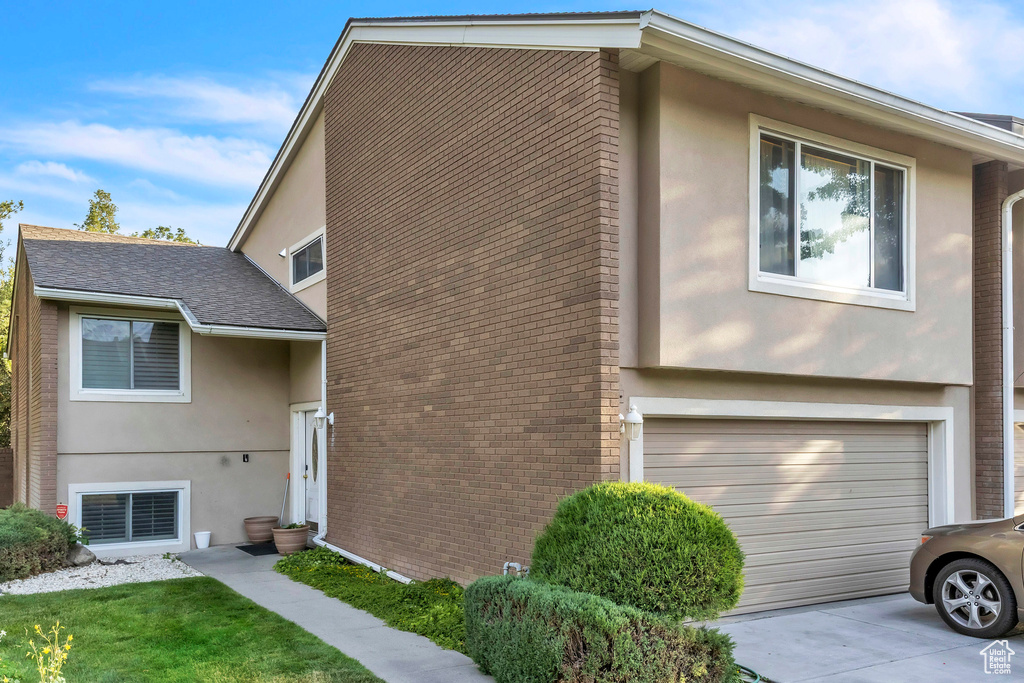 View of front of home with stucco siding and brick siding