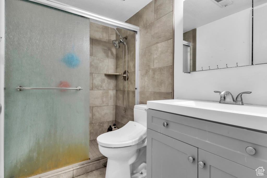 Bathroom featuring a stall shower and vanity