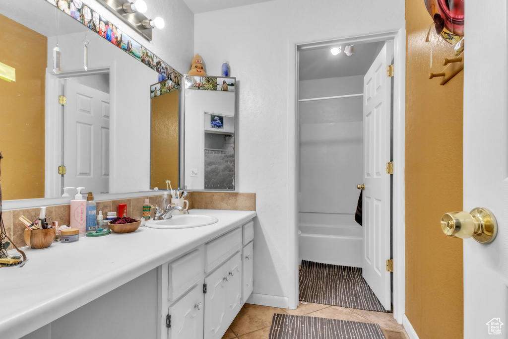 Full bath featuring vanity, tile patterned flooring, and shower / bathtub combination