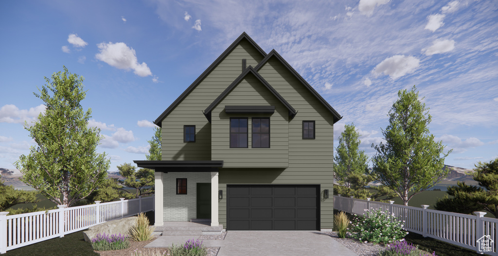 View of front of home with an attached garage and driveway