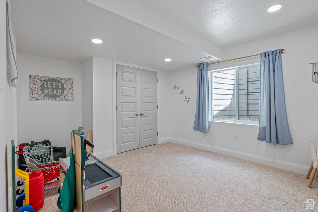 Playroom with carpet floors and recessed lighting