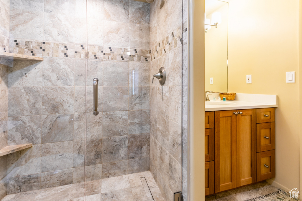 Full bath with a shower stall and vanity