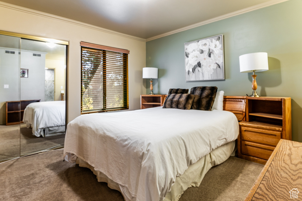 Carpeted bedroom featuring ornamental molding