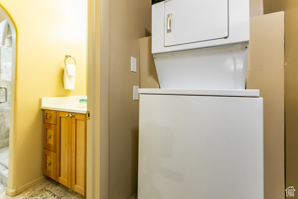 Laundry room featuring stacked washer and clothes dryer