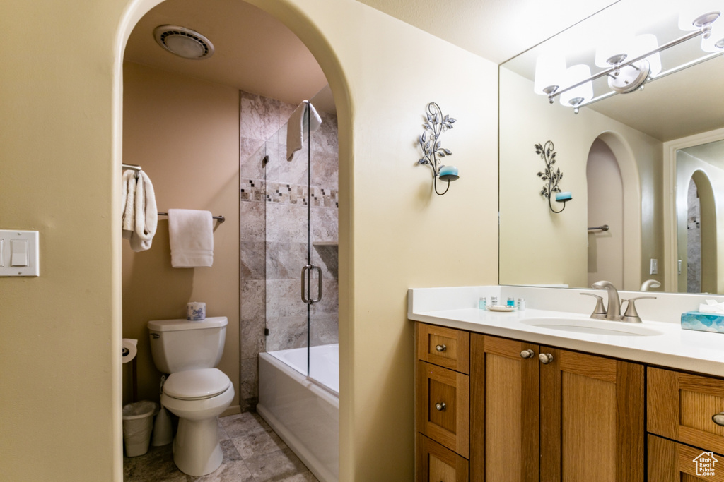 Full bathroom with vanity and bath / shower combo with glass door