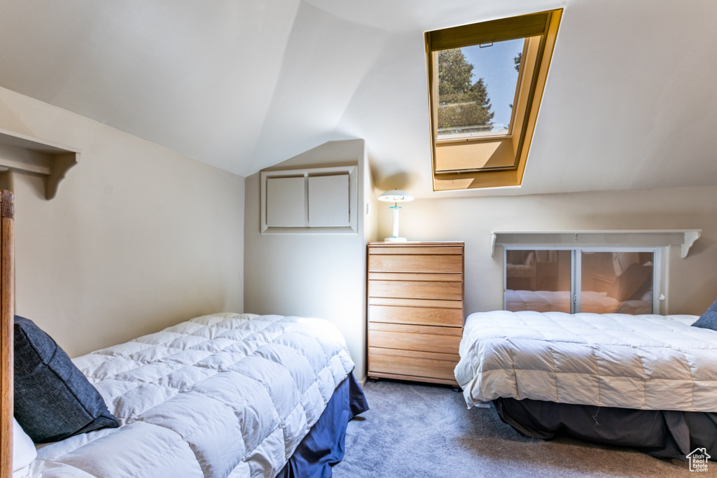Carpeted bedroom featuring vaulted ceiling