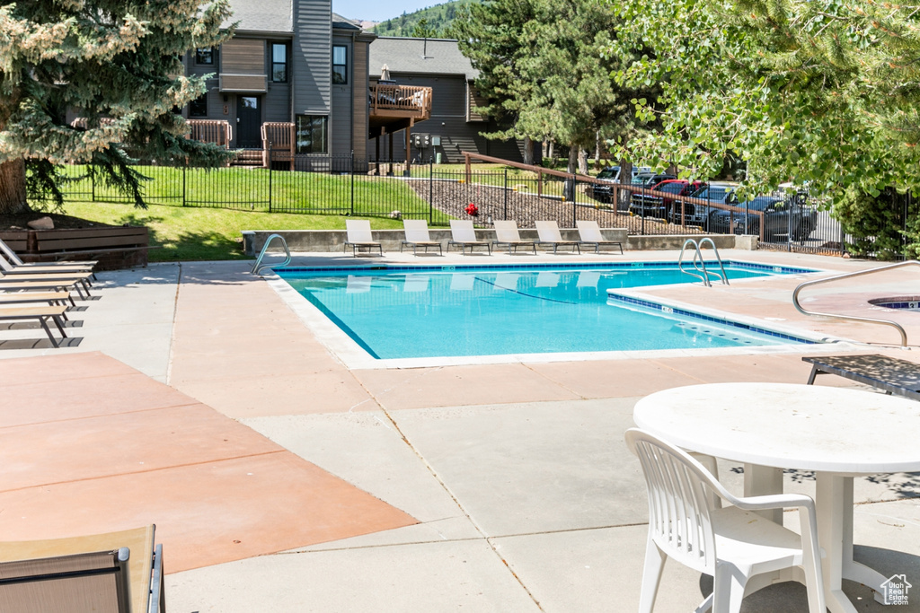 Community pool with a patio area