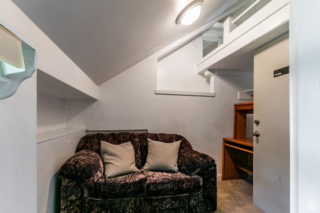 Sitting room with carpet floors and vaulted ceiling