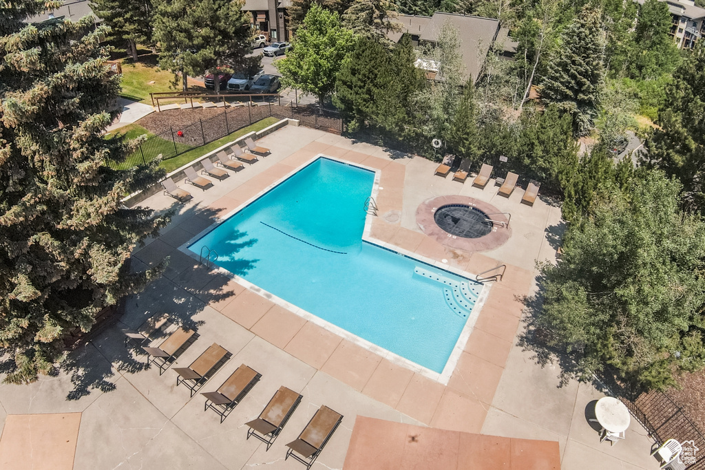 Community pool with a patio