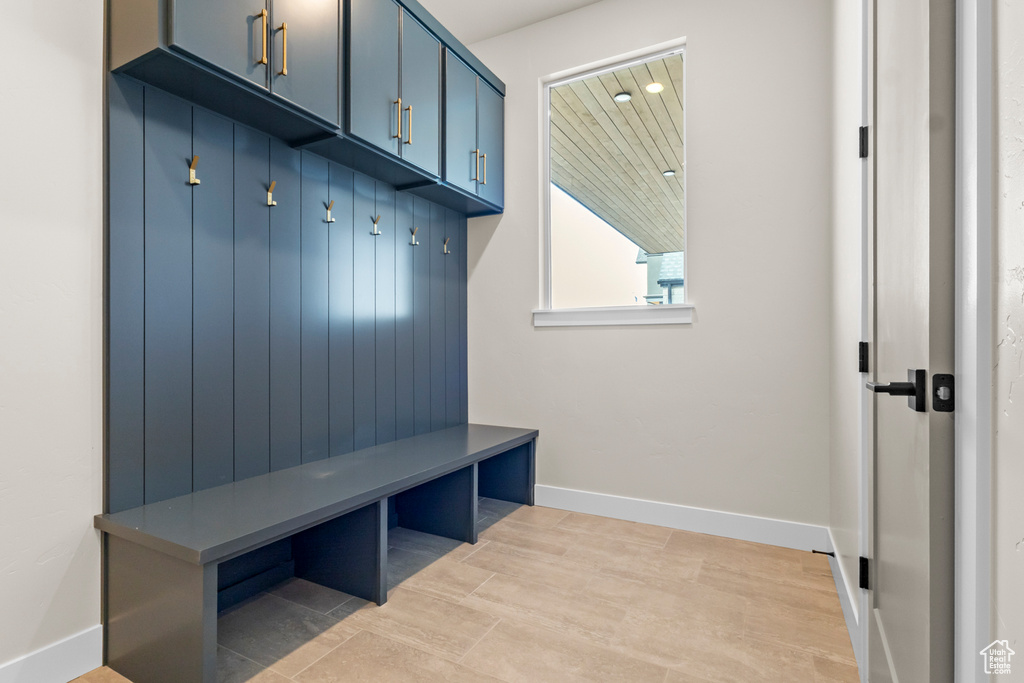 Mudroom with baseboards and light wood-style flooring