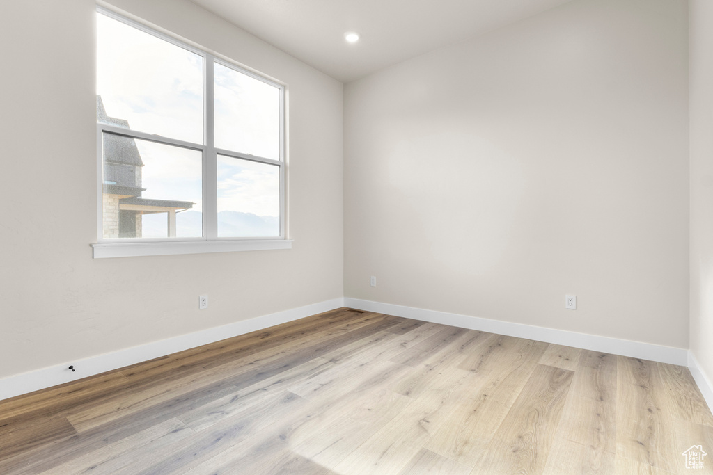Spare room featuring wood finished floors and recessed lighting