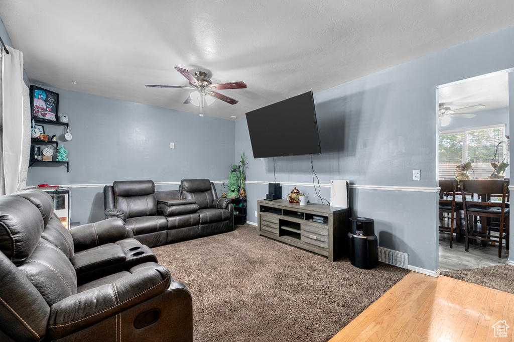 Living room featuring a ceiling fan and wood finished floors