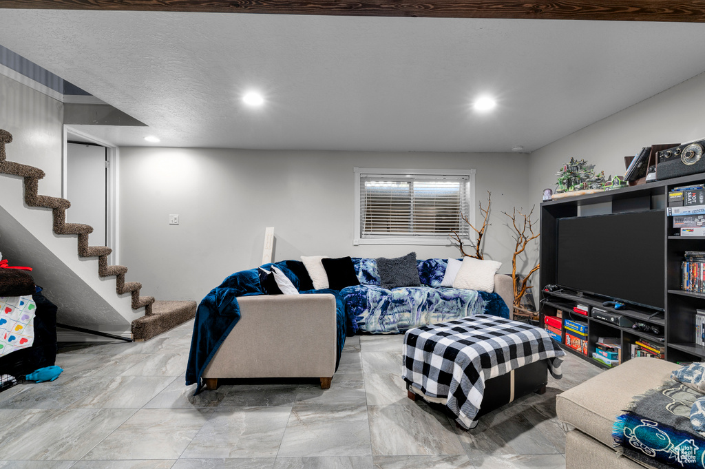 Living area featuring stairs and recessed lighting