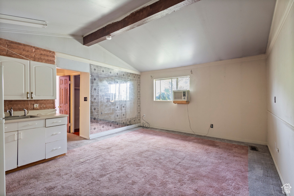 Kitchen featuring light carpet, white cabinetry, and light countertops