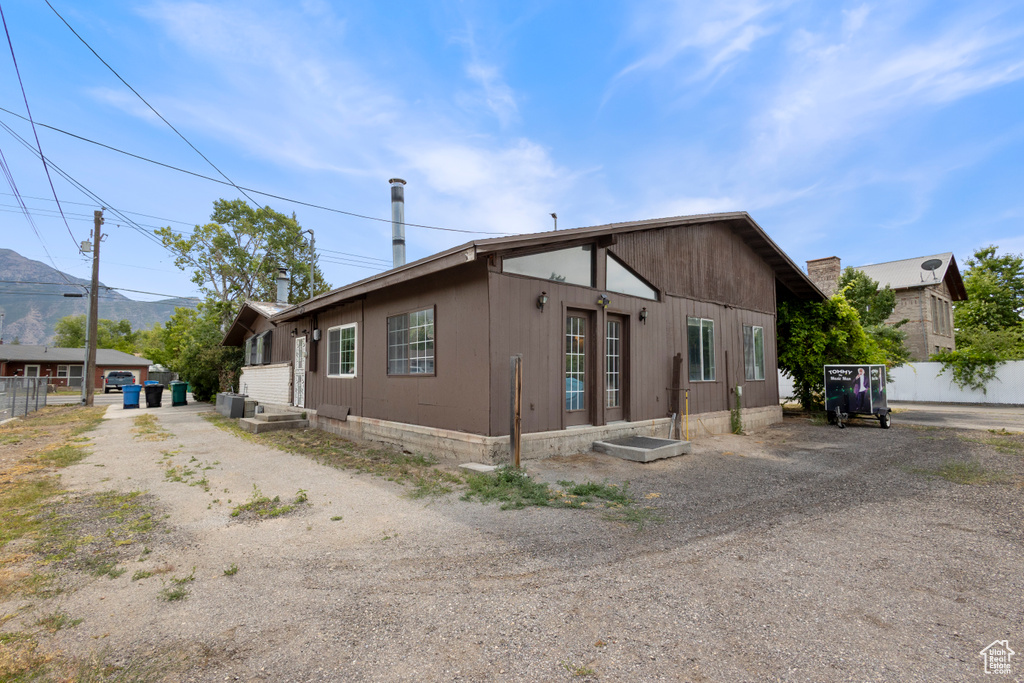 View of property exterior with dirt driveway