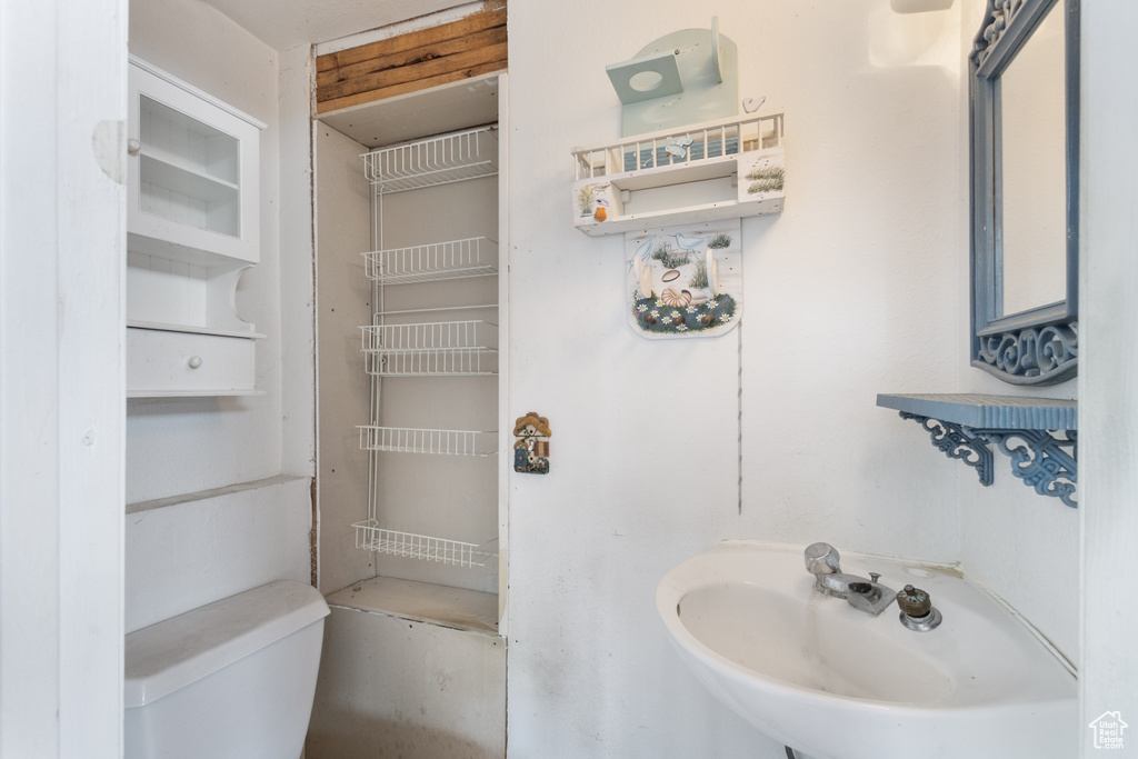 Half bathroom featuring a sink and toilet