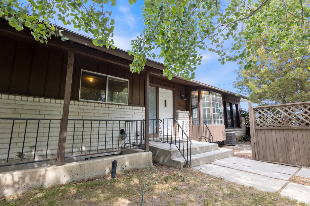 Property entrance with board and batten siding and brick siding