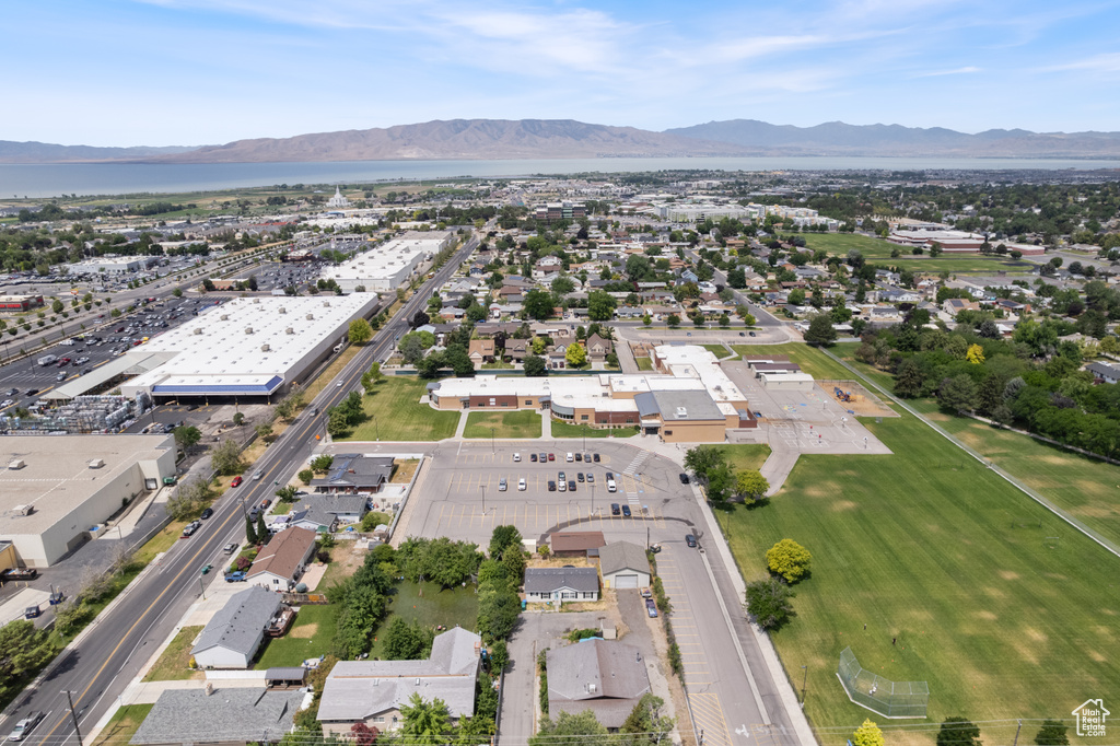 Aerial view of property and surrounding area with a mountain backdrop