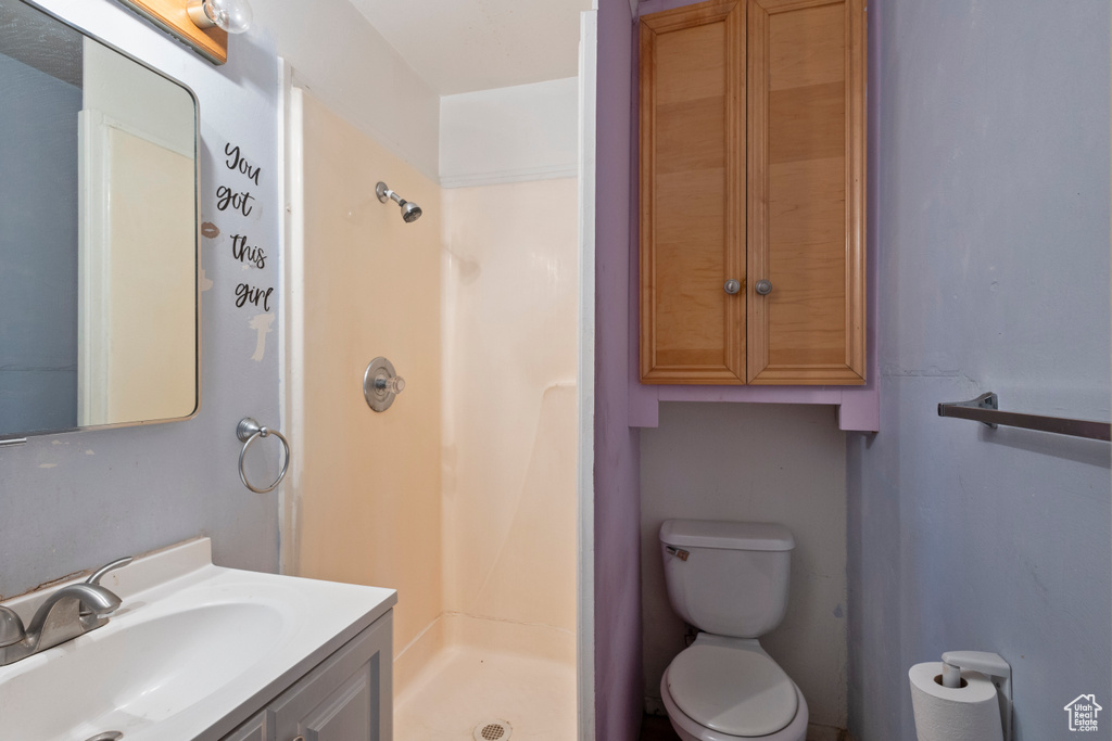 Bathroom with a shower stall and vanity